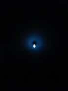 Minimalist air purification device emitting a soft blue light in a bright, airy room.