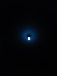 A focused creator working late with blue ambient lighting and minimalist decor.