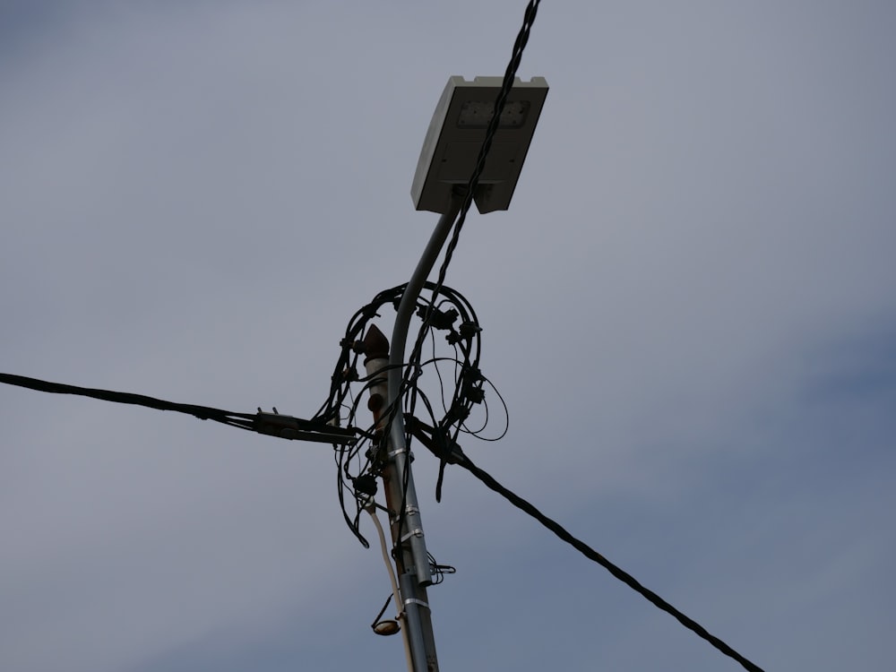 a telephone pole with a bunch of wires attached to it