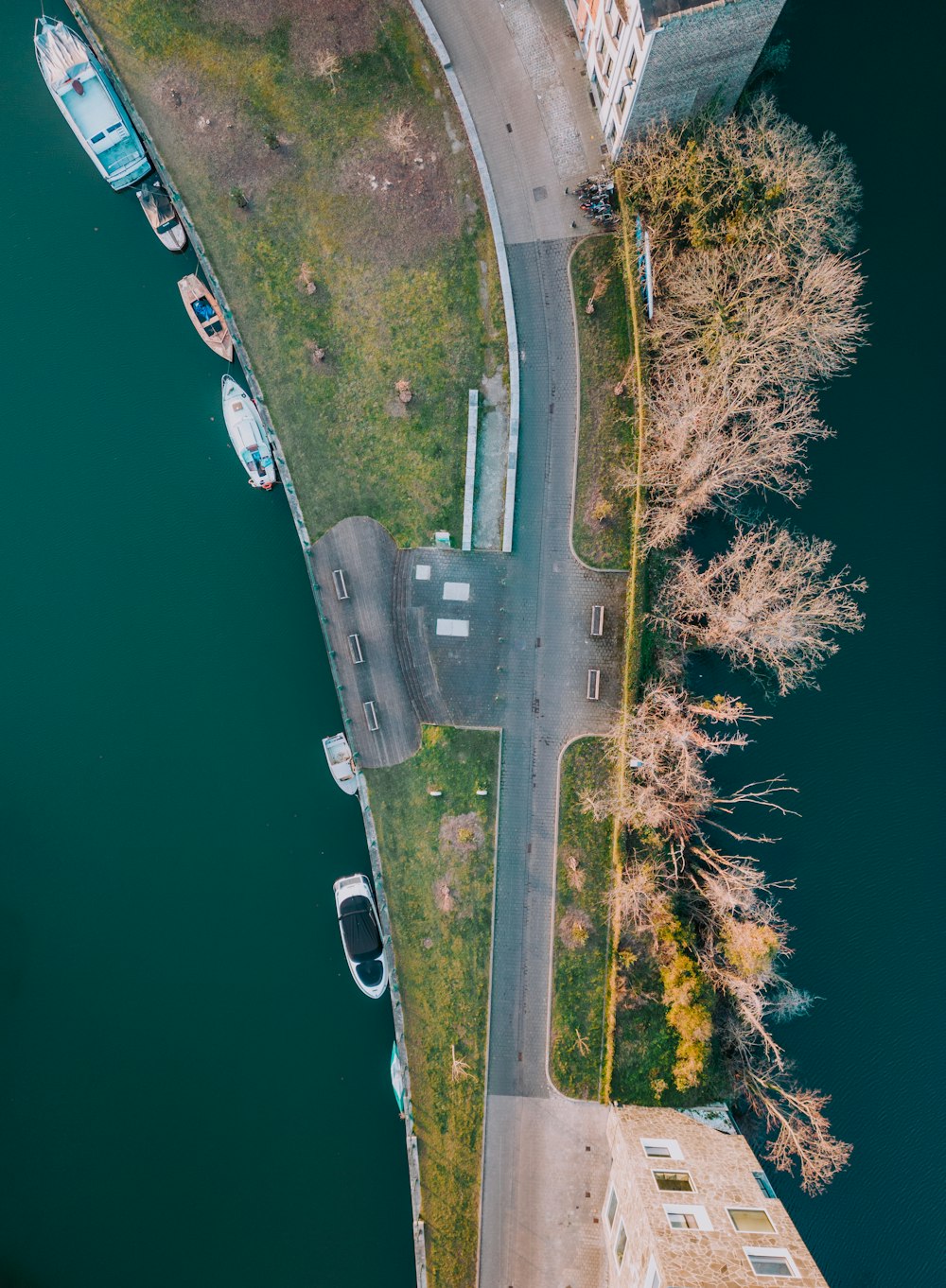 an aerial view of a parking lot next to a river