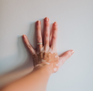 a woman's hand with a lot of cream on it