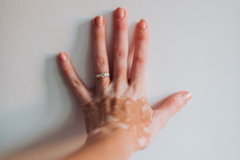 a woman's hand with a lot of cream on it