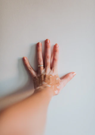 a woman's hand with a lot of cream on it