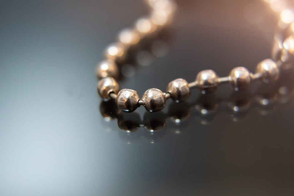 a close up of a beaded necklace on a table
