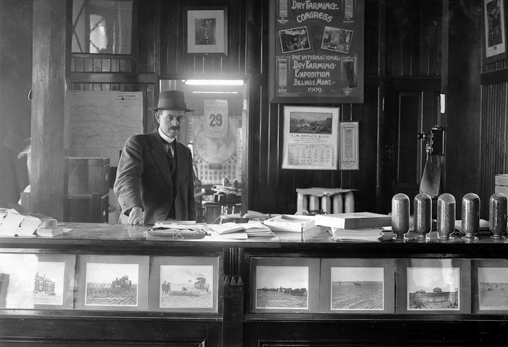 a man standing behind a counter in a restaurant