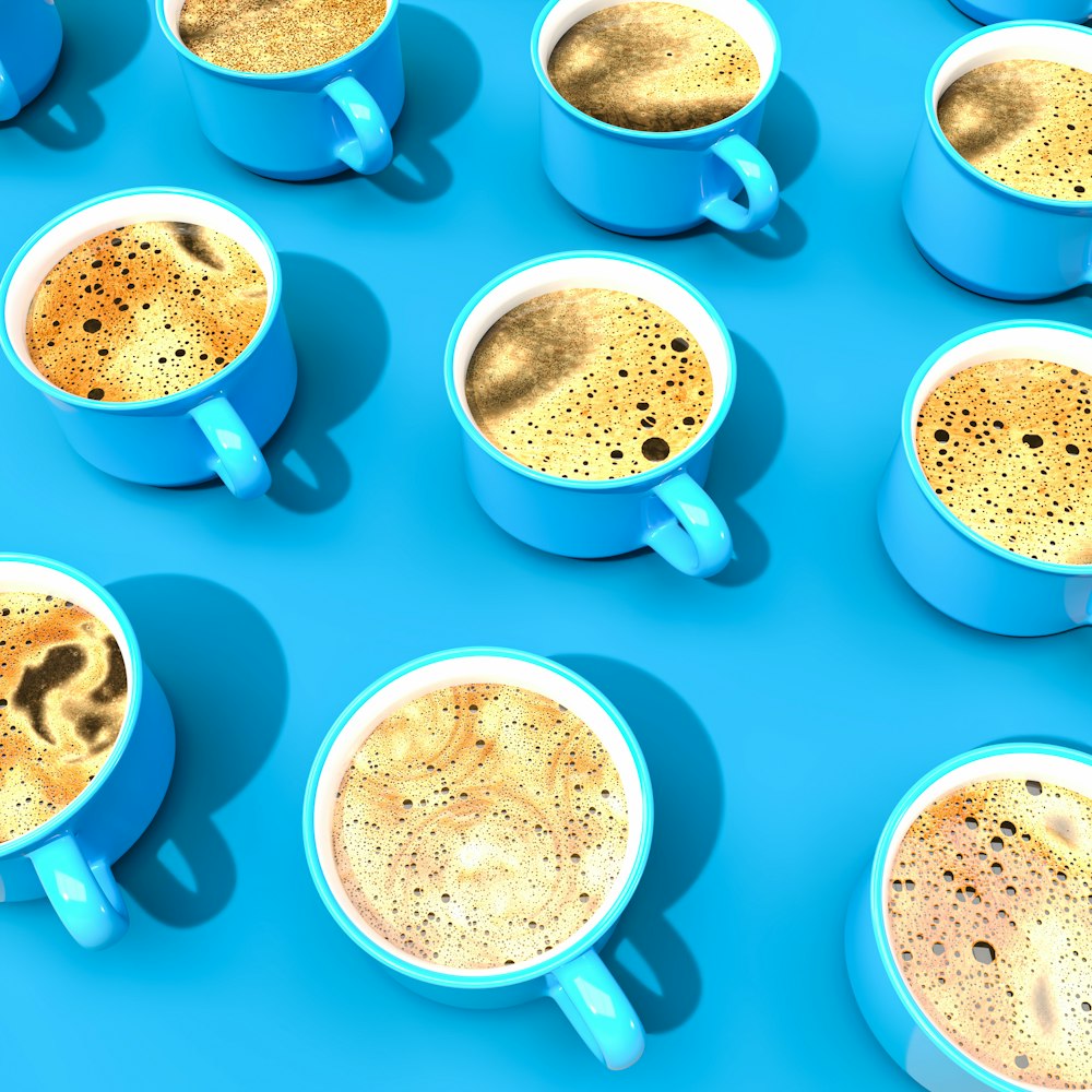 a group of coffee cups sitting on top of a blue table