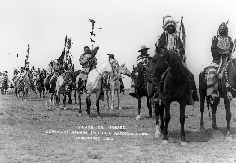 a group of men riding on the backs of horses