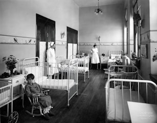 a black and white photo of a hospital room