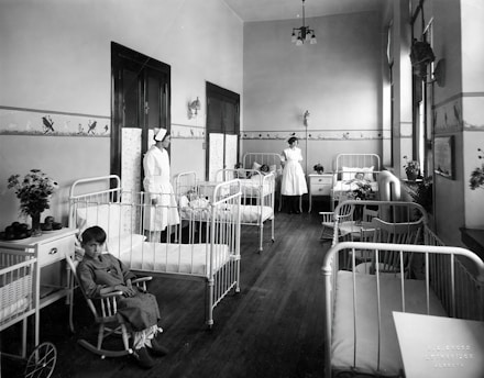 a black and white photo of a hospital room