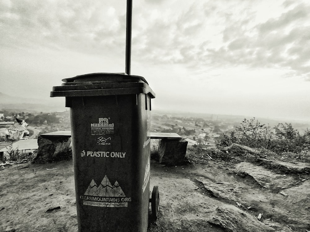 a trash can sitting on top of a hill