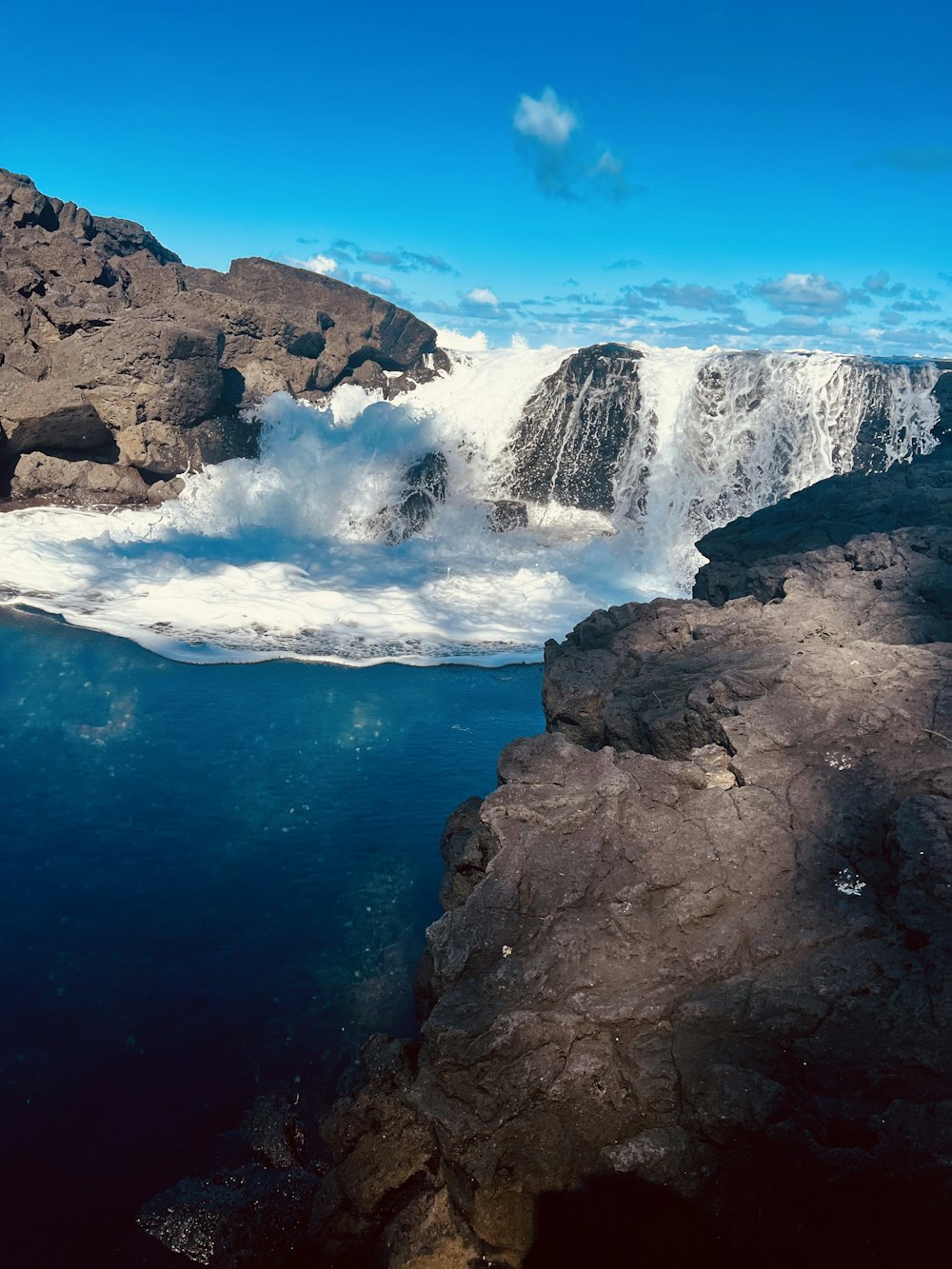 a view of a waterfall from the water