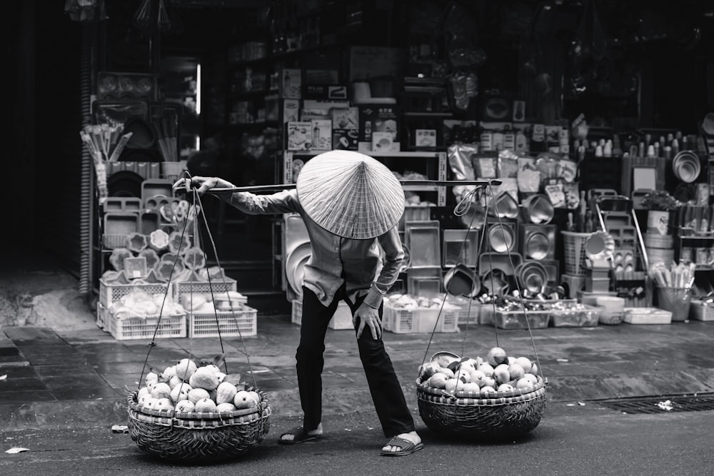 a person with an umbrella and two baskets of eggs