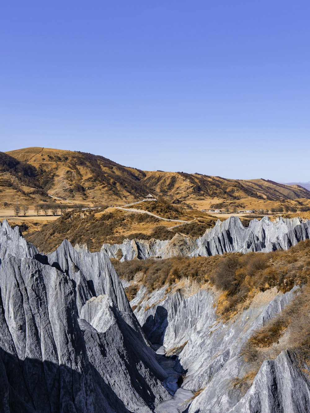 a view of a mountain range with a road going through it