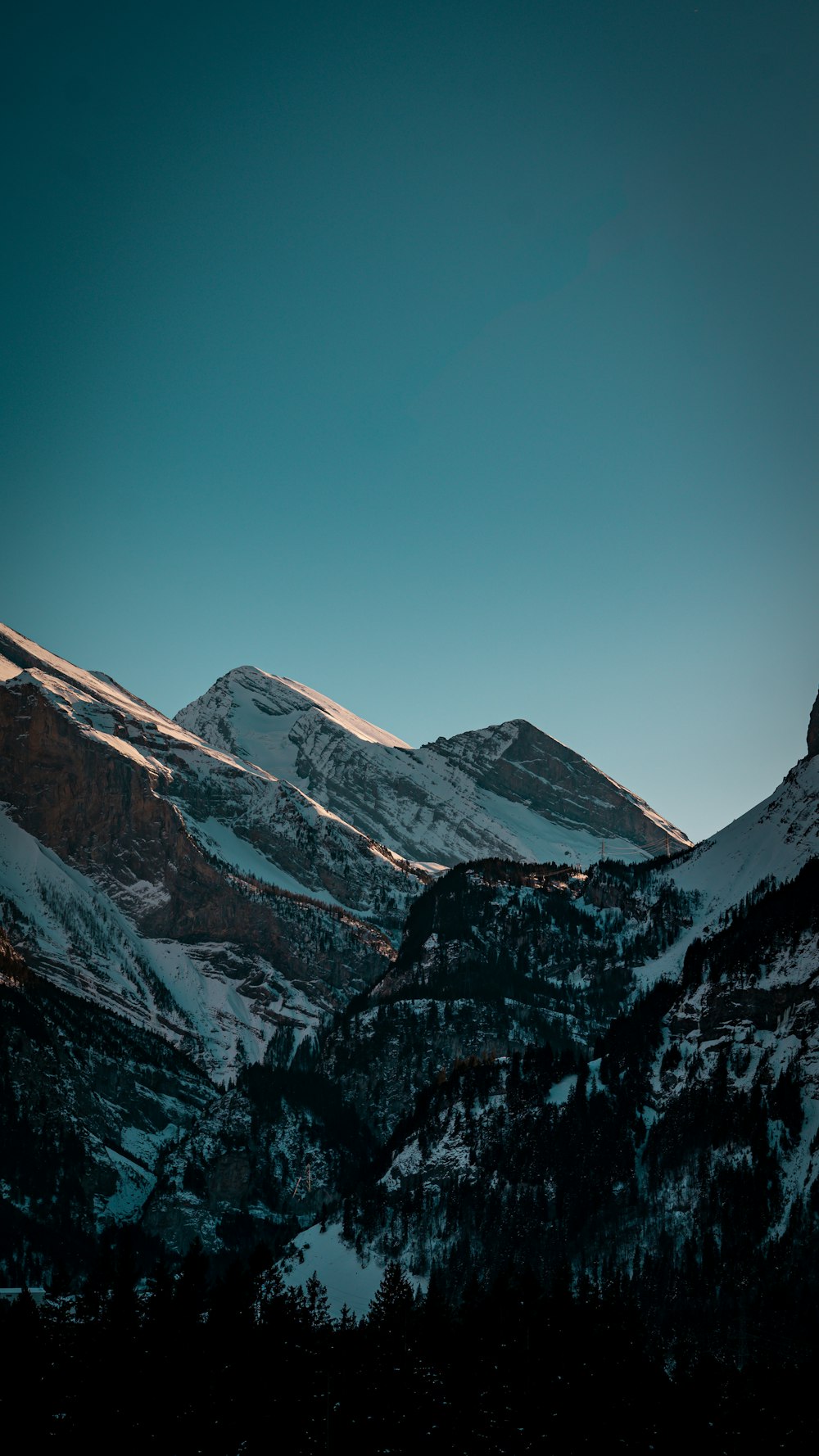 a view of a mountain range with snow on it