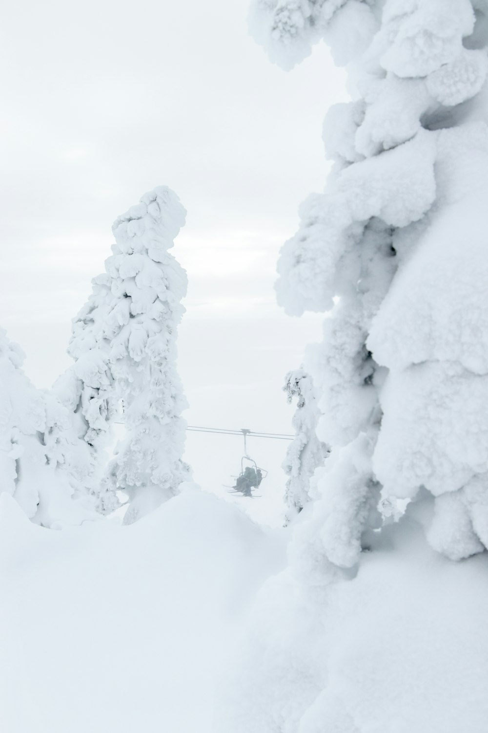 a man riding a snowboard down a snow covered slope