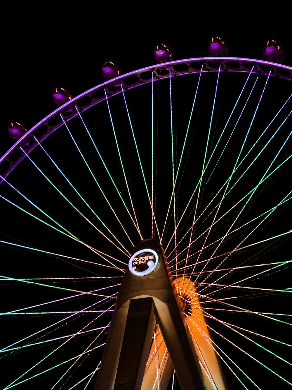 a big wheel that is lit up at night