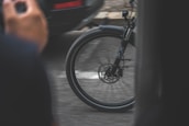 A close-up of a bicycle wheel spinning rapidly on a smooth path.