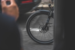 A close-up of a bicycle wheel spinning rapidly on a smooth path.