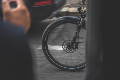 Close-up of a motorcycle wheel spinning with motion blur on a white background.