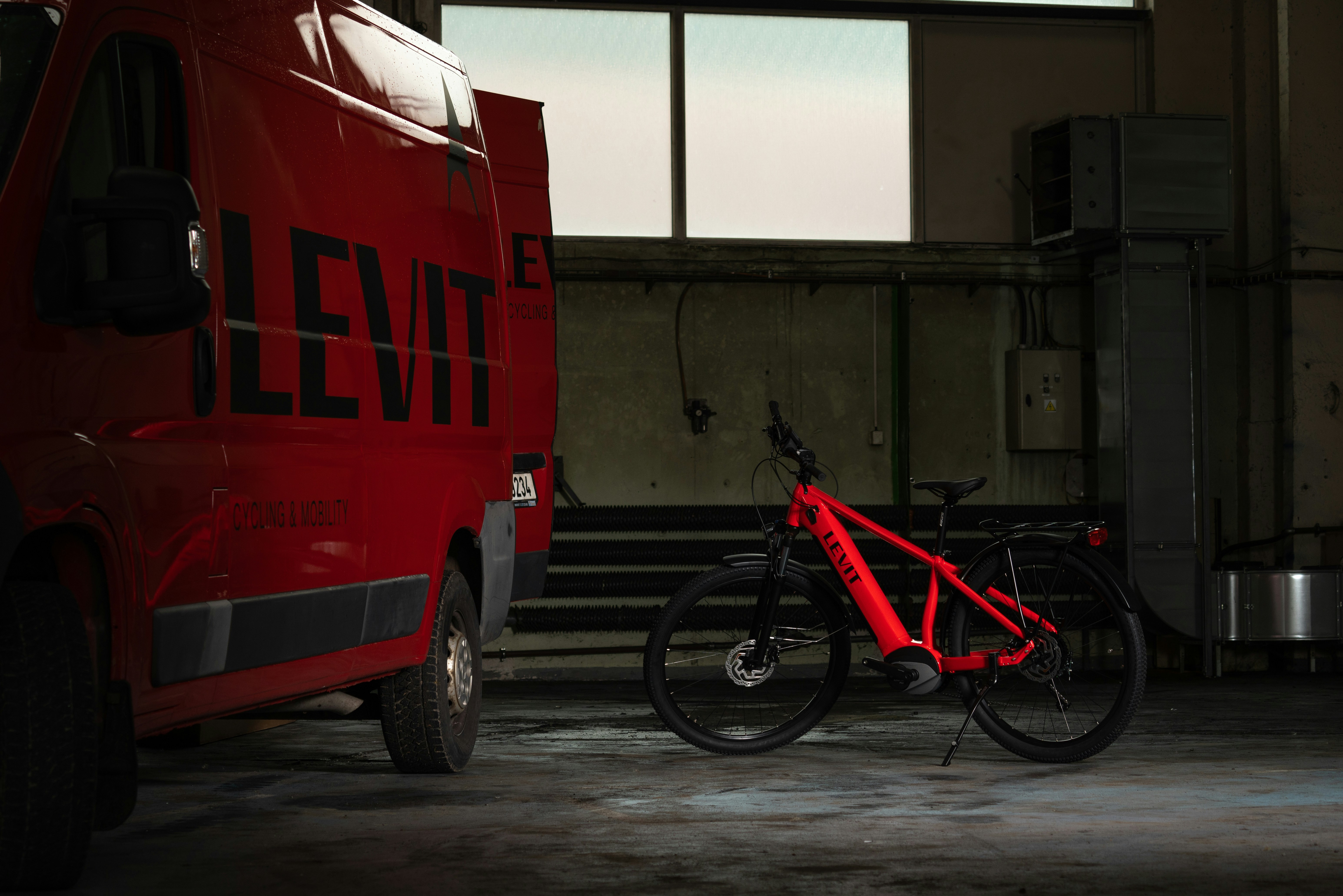 a red bike parked next to a red truck