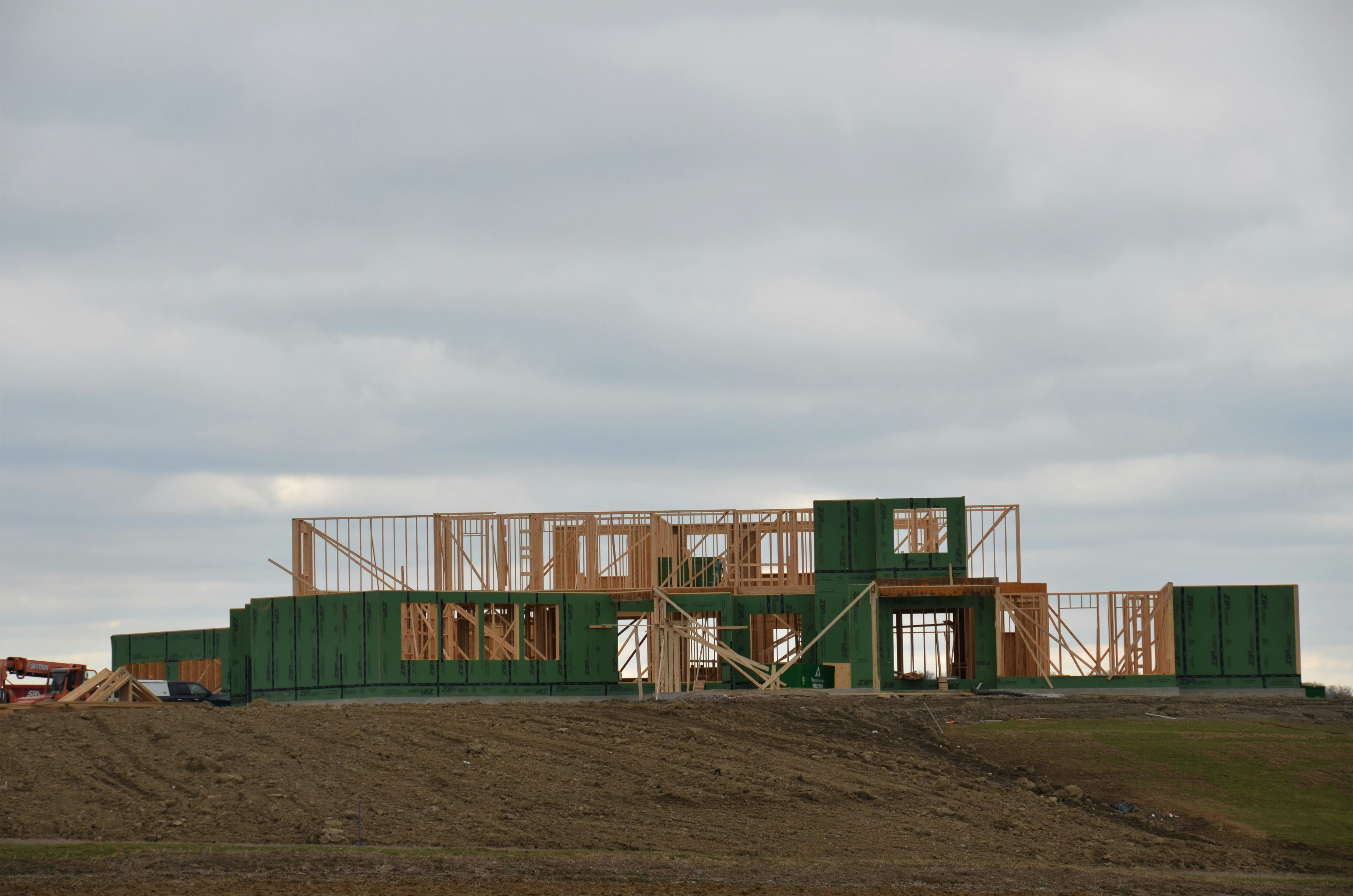 New residential home under construction with framing and foundation work visible