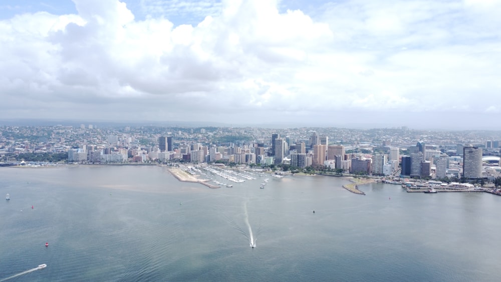 a large body of water with a city in the background