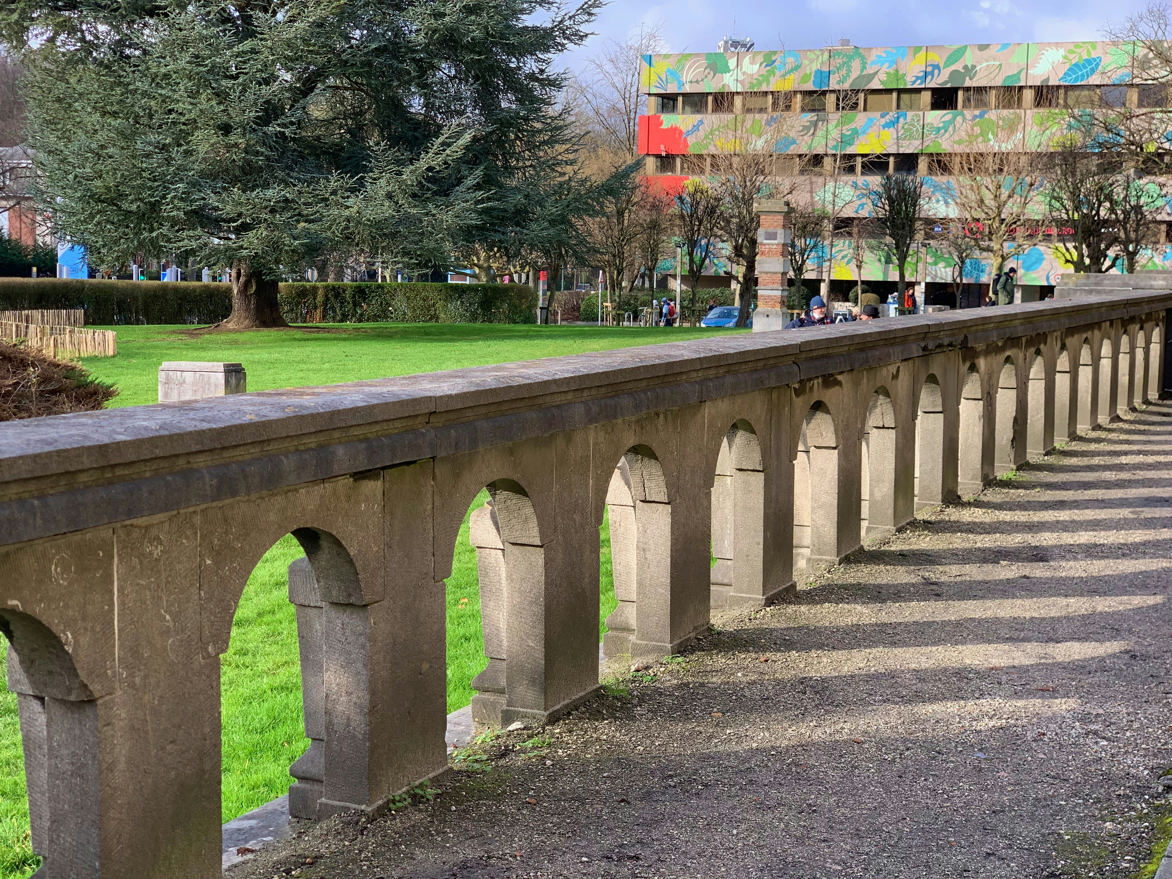 a long concrete bridge with a building in the background