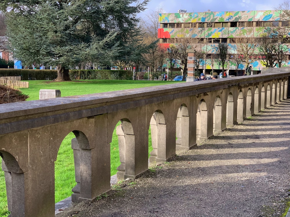 a long concrete bridge with a building in the background