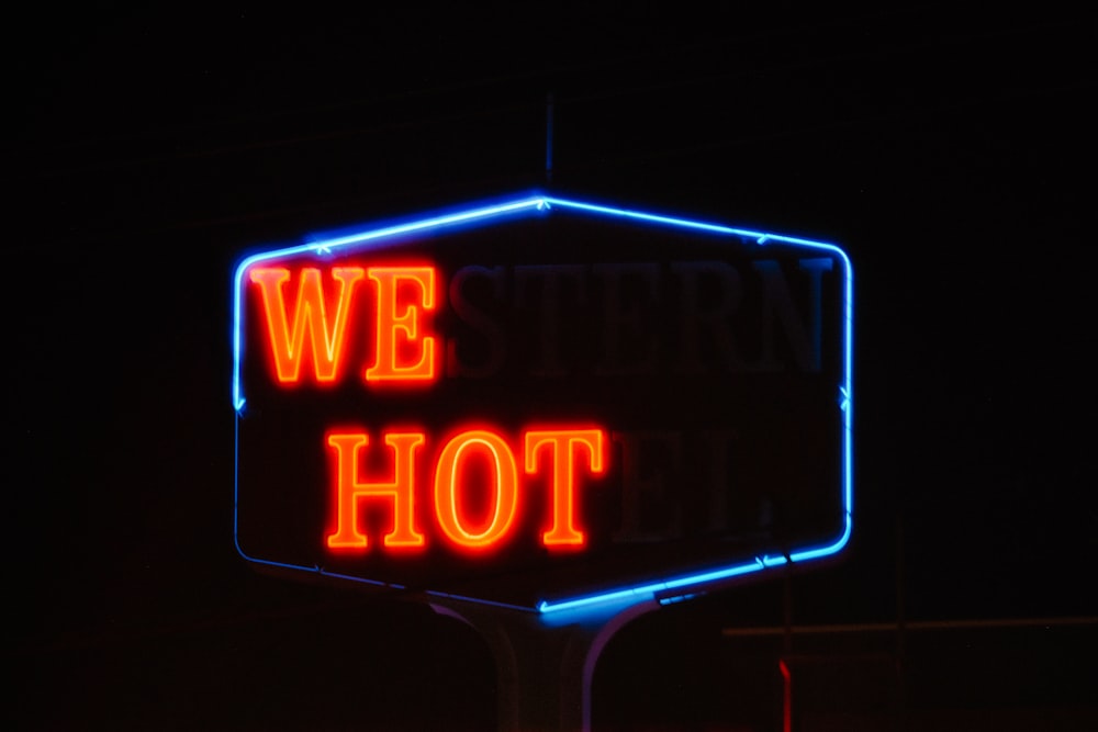 a neon sign that says we hot on it