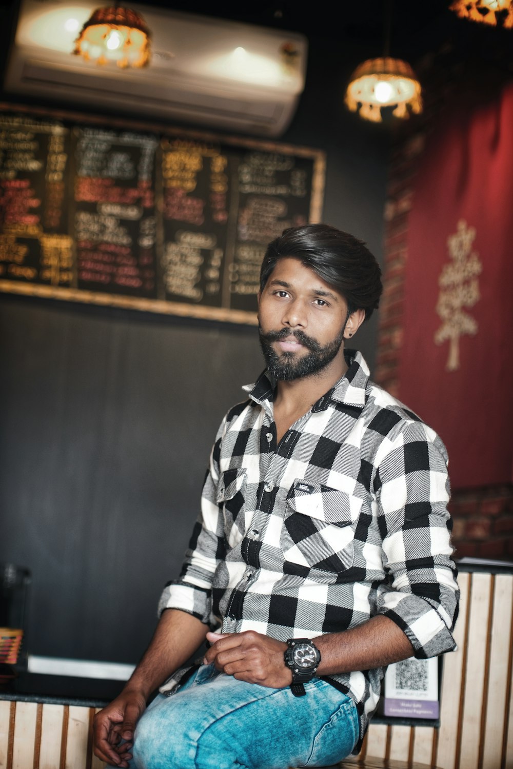 a man sitting on a bench in a restaurant