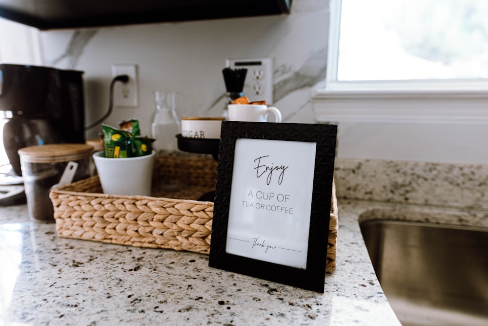 a picture frame sitting on top of a kitchen counter