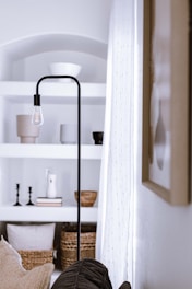 a bedroom with a bed and a lamp