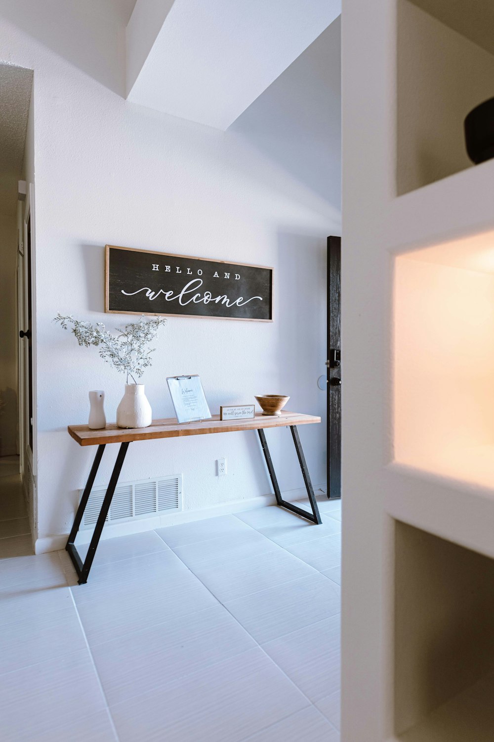 a room with a table and a sign on the wall