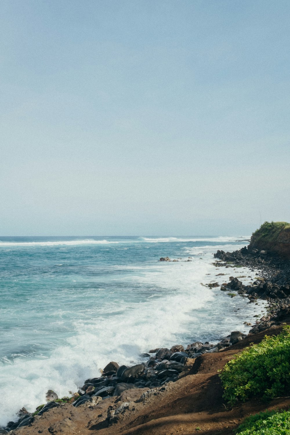 a view of the ocean from a rocky shore