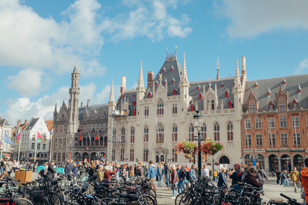 a group of people standing around a large building