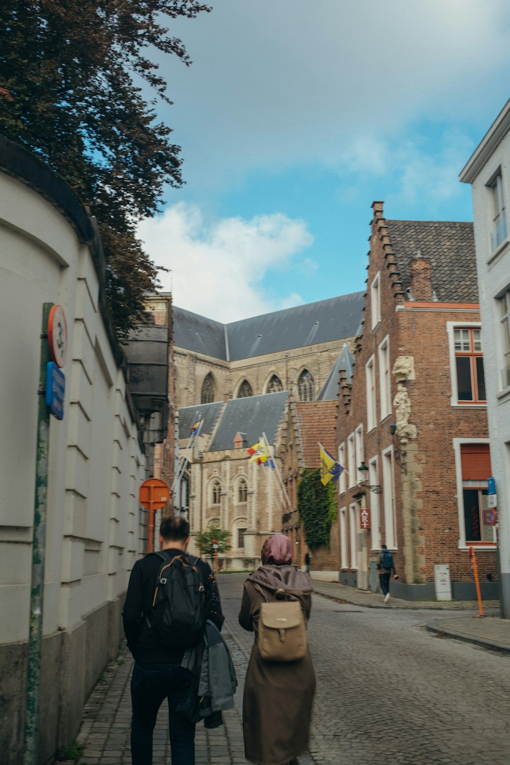 a couple of people walking down a street