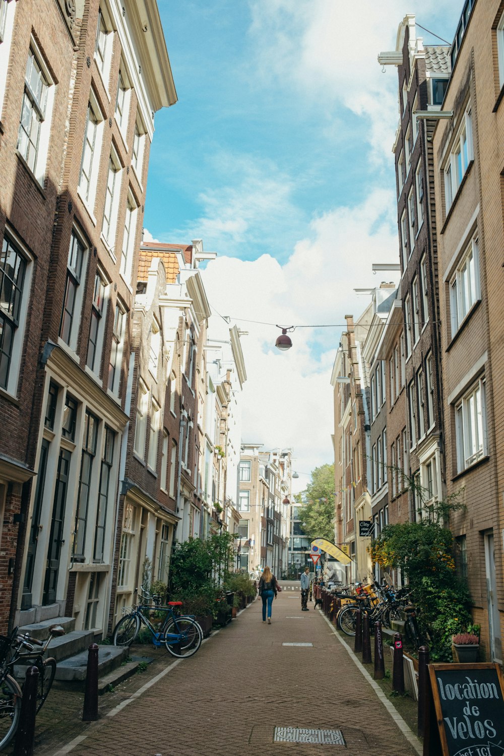 a narrow street lined with tall brick buildings