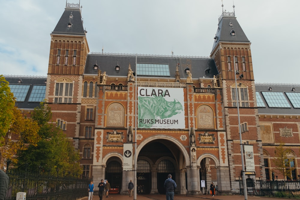 a large building with two towers and a sign on the front