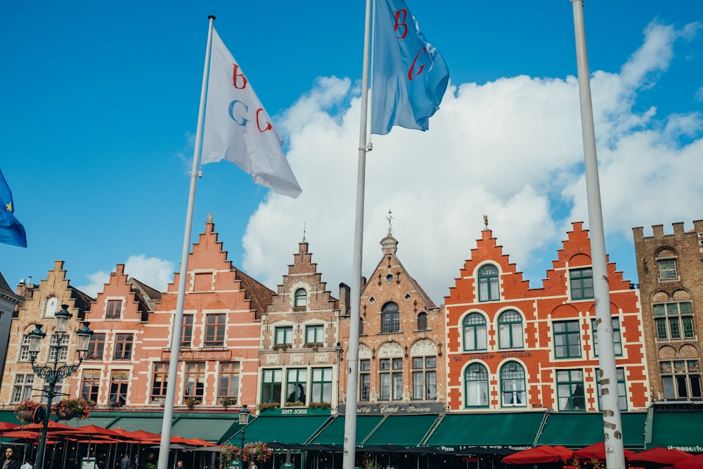 a row of buildings with flags flying in front of them