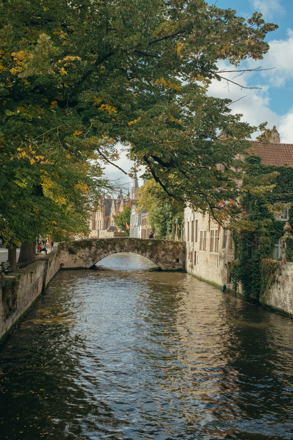 a river running through a city next to tall buildings