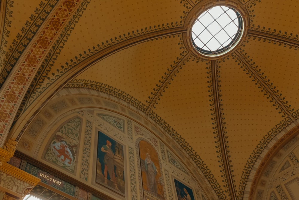 the ceiling of a church with paintings on it