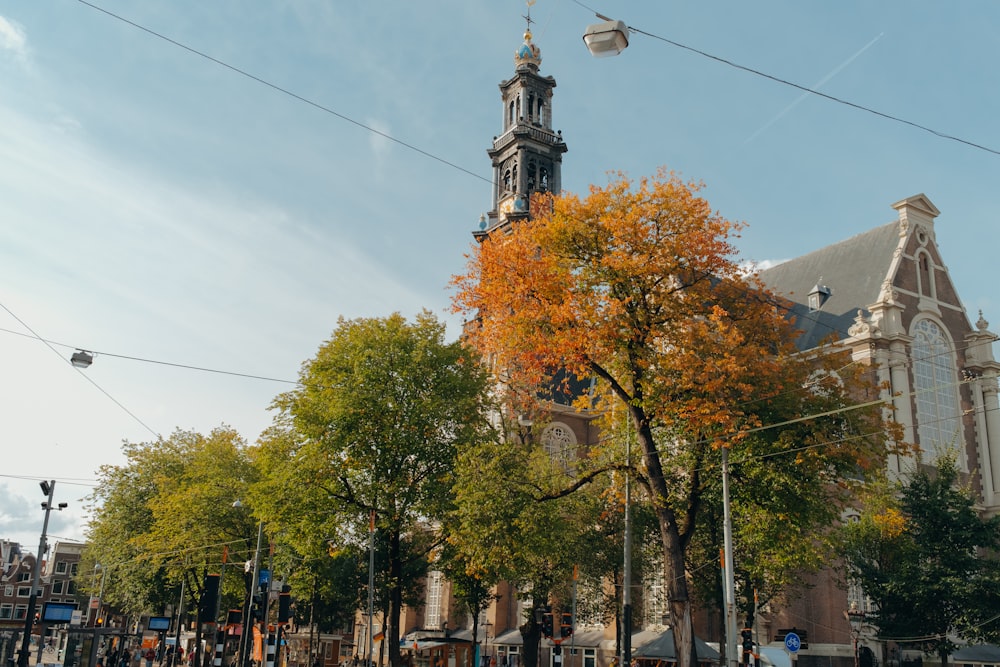 a tall church tower towering over a city street