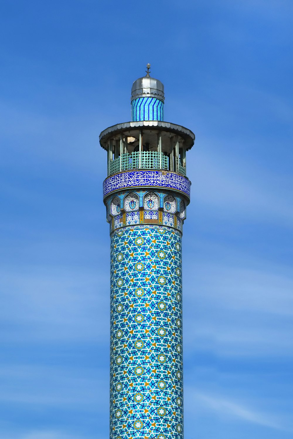 a tall blue and white tower with a clock on it's side