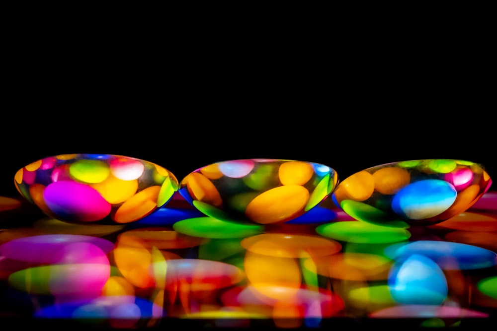 a group of colorful balls sitting on top of a table