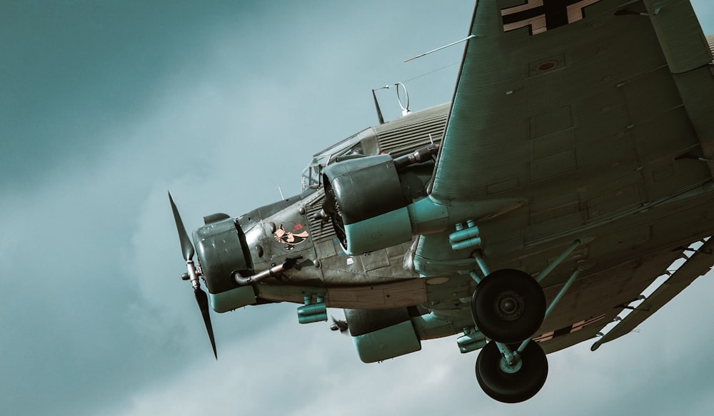 an old world war ii fighter plane flying in the sky