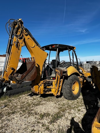 Close-up of a heavy-duty loader machine ready for rental on a clear day.