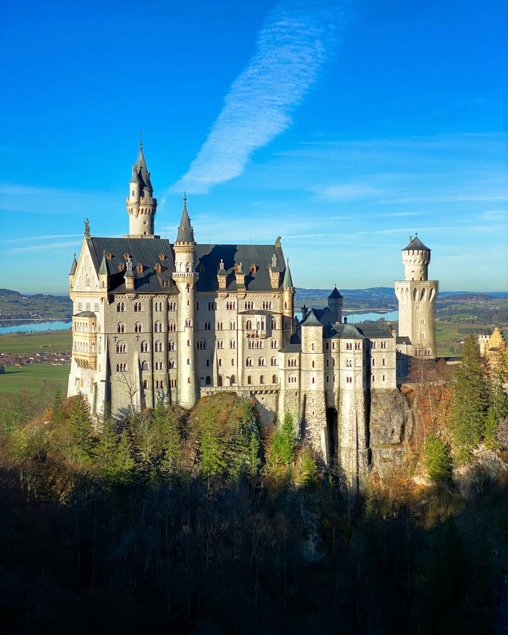 a large castle with towers on top of a hill