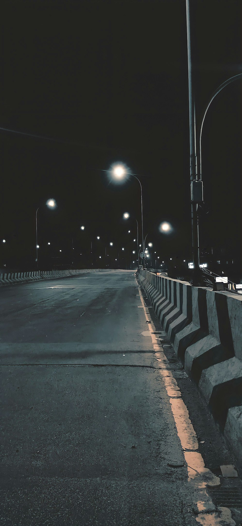 an empty street at night with street lights