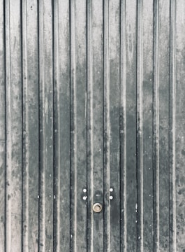 a close up of a metal door with two knobs