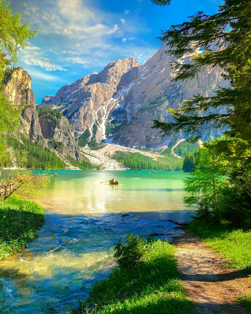 a painting of a lake surrounded by mountains